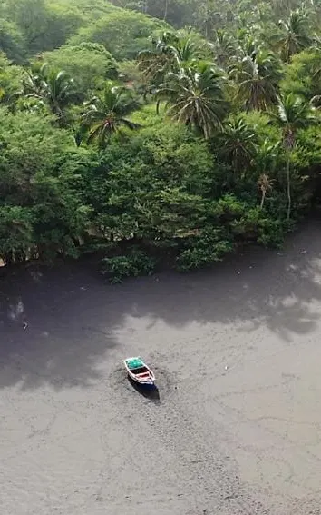 Fishing boat on a black sand beach